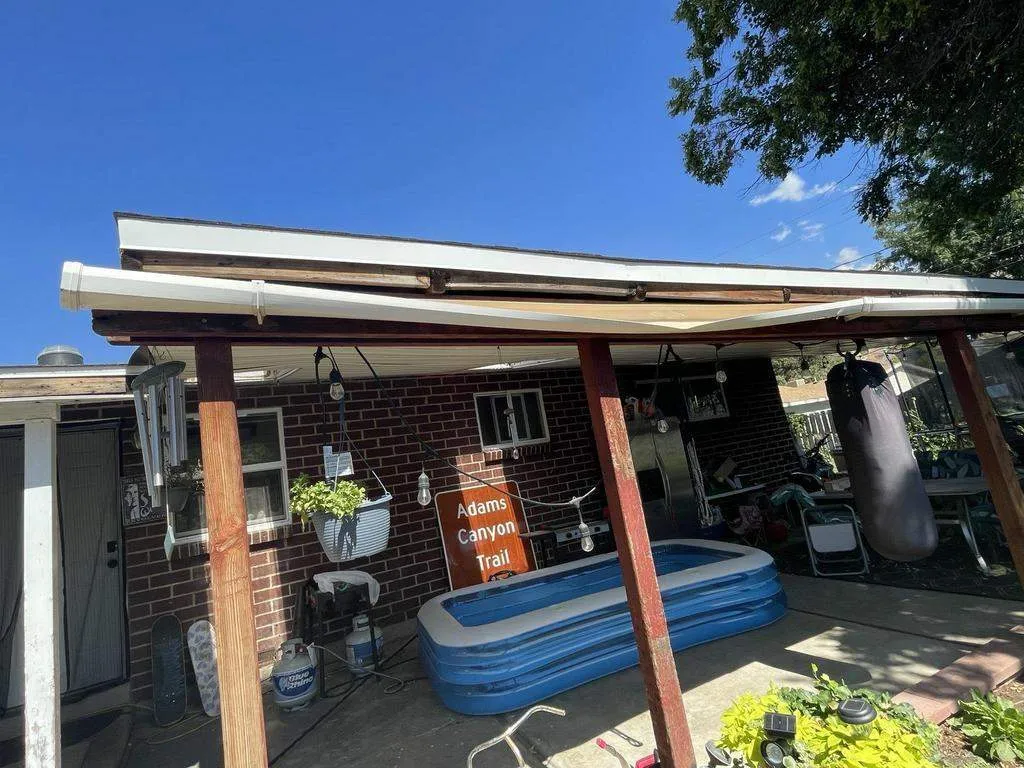 Sagging white gutter running along a covered patio roof